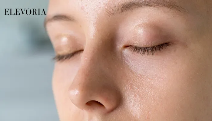 A close-up view of a woman with eyes closed, showing an oily shine along her nose and forehead alongside normal-to-dry cheek texture.